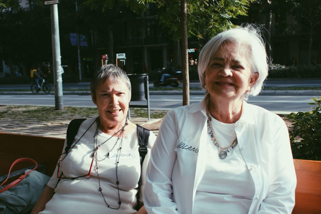 Aurora i Jolange, participants grans del projecte Mirades intergeneracionals, somrient en un banc de Barcelona